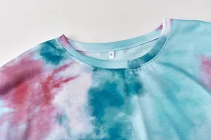 Collar detail close-up of women fashion tie-dye long sleeve top with size label inside.