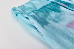 Close up detail of women casual tie dye pants waistband and pocket texture display.
