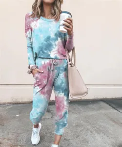 Detailed view of women's tie-dye long sleeve sweatshirt and sweatpants lounge set in outdoor scene.