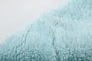 Light blue plush fleece fabric texture detail closeup shot, soft fuzzy winter material