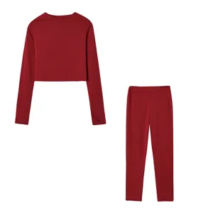 Detailed view of the women's solid red long-sleeve crop top and matching slim pants set.