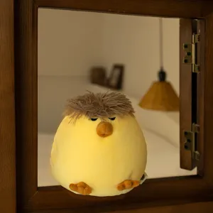 Adorable veilleuse en peluche jaune avec des cheveux bruns pelucheux, décoration mignonne.
