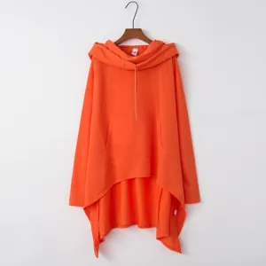Solid color oversized long sleeve hooded sweatshirt with irregular hem, vibrant orange top.
