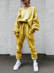 Casual yellow oversized tracksuit detail view, comfortable long sleeve sweatshirt and sweatpants.