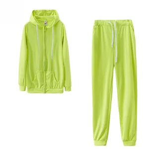 Neon green zip-up hoodie and sweatpants set detail showing drawstring and pocket design.