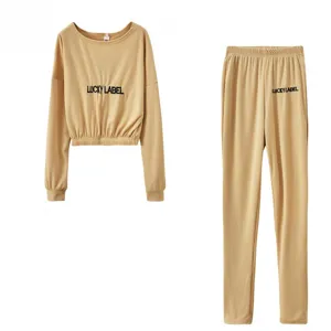 Khaki ribbed two-piece loungewear set featuring long sleeves and comfy casual pants with text detail.