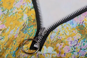 Floral print long sleeve women top metal ring zipper detail close up clothing view