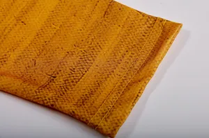 Close-up view of the long sleeve cuff with unique patterned fabric and fine yellow stitching.