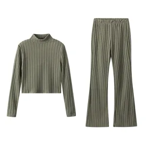 Green ribbed knit set featuring a high neck long sleeve top and flare pants for women.