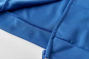 Blue zip hoodie detail shot showing fine stitching and durable zipper quality for activewear.