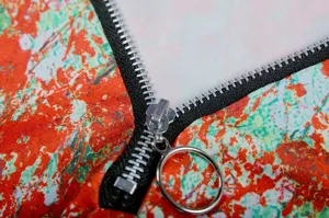 Detailed view of the women's floral long sleeve top zipper and vibrant fabric texture.