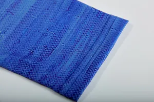 Close-up detail of blue patterned long sleeve cuff with neat double-stitching construction.
