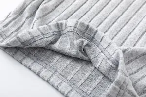 Close-up detail of soft grey ribbed knit fabric featuring neat stitching and texture.