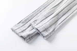 Detailed shot of grey ribbed knit fabric cuff, soft texture for autumn clothing pieces.