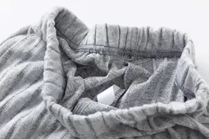 Gray striped knit pants waistband detail close up, soft comfortable fabric, casual loungewear.