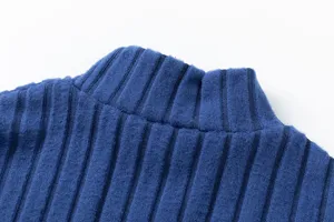 Blue ribbed knit sweater detail showing high collar design and soft fabric texture.