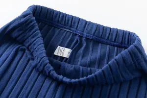 Detailed view of women casual knit trousers elastic waistband and interior size care label.