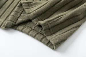 Detailed view of the olive green ribbed knit fabric, showing fine texture and stitching.