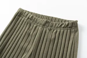 Detailed view of the elastic ribbed waistband on casual knit trousers for women autumn style.