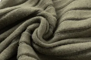 Close-up of green ribbed knit fabric texture for autumn hooded sweatshirt two-piece set.