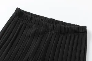 Close-up detail of stylish black ribbed knit pants showcasing elastic waistband texture.