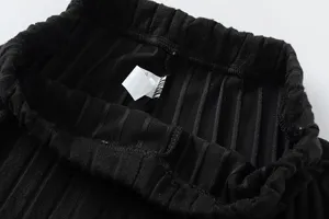 Black ribbed knit trousers waistband detail, comfortable elastic design for daily casual wear.