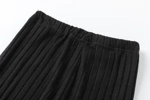 Black ribbed knit pants elastic waistband close-up detail view texture shot display