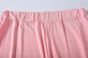 Close-up detail of pink casual pants elastic waistband, soft fabric, clean stitching display.