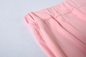 Pink casual sports pants elastic waistband detail, soft fabric texture close-up view.