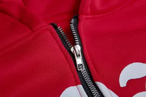 Nahaufnahme eines roten Kapuzensweatshirts mit glattem Metallreißverschluss und Schaumstoffdruck.