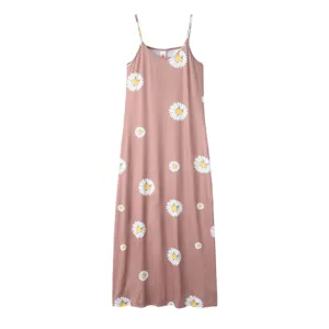 Closeup detail view of the floral print pattern and fine spaghetti straps on the pink long dress.