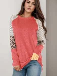 Detailed view of women's color-block long sleeve top featuring striped and leopard sleeves.