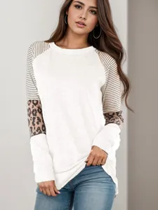 Detailed view of women's long sleeve colorblock top with stylish striped and leopard sleeves.