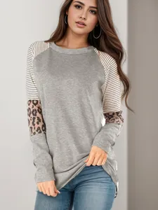 Close-up detail of the women's color-block raglan sleeve top showcasing striped and leopard patterns.