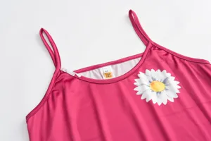 Detailed closeup view of women pink slip long dress featuring white daisy floral print and spaghetti straps