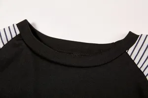 Detail view of women's black long sleeve t-shirt collar and striped raglan sleeves.
