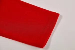Red long sleeve T-shirt fabric detail and neat double stitching cuff close up view.