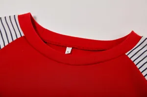 Close-up detail of the women's red crewneck t-shirt collar, showing soft fabric and size tag.