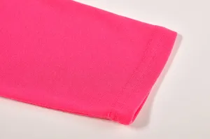 Close-up view of the vibrant pink sleeve cuff and fine stitching detail on a women's top.