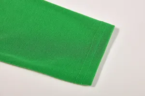 Green knit fabric sleeve detail, fine double-needle stitching, casual T-shirt cuff.