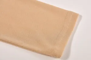 Close-up detail of women's long sleeve t-shirt sleeve cuff fabric texture knit beige