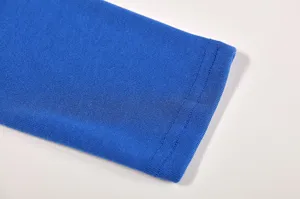 Blue knit long sleeve cuff detail shot showing fine stitching texture and soft fabric material.