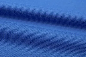 Close-up detail of soft blue knitted fabric, showing fine texture and comfortable material quality.