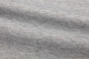 Close-up view of soft grey knit fabric showing fine texture and elastic ribbed material detail.