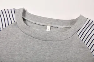 Detailed view of women casual long sleeve crewneck t-shirt featuring striped raglan sleeves.