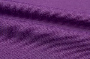 Purple knitted fabric detail close up, soft and elastic textile texture for comfortable clothing.