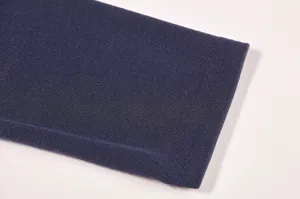 Dark blue knit long sleeve cuff detail, fine ribbed fabric texture, clean minimalist product view.