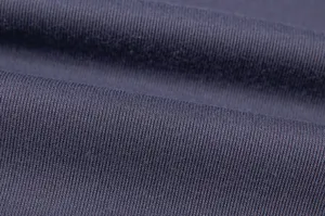 Close-up detail of dark blue ribbed knit fabric showing fine texture and elasticity.