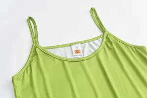 Green slim fit spaghetti strap long camisole dress detail view, summer fashion style.