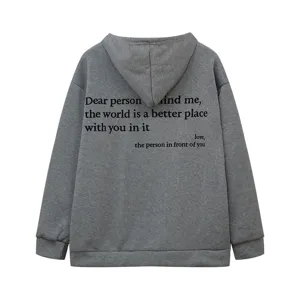 Detailed view of the back of a grey fleece hoodie featuring an inspirational English text print.